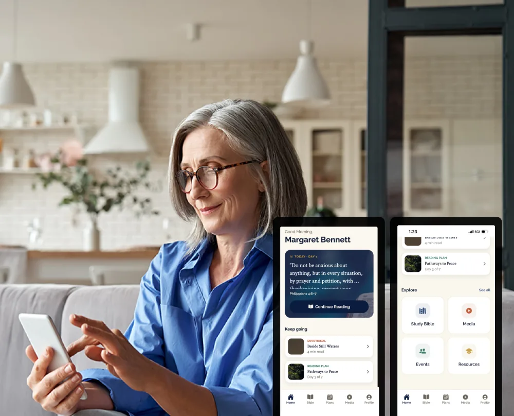 A senior-living resident reading a Scripture passage in the daily formation app on her phone.
