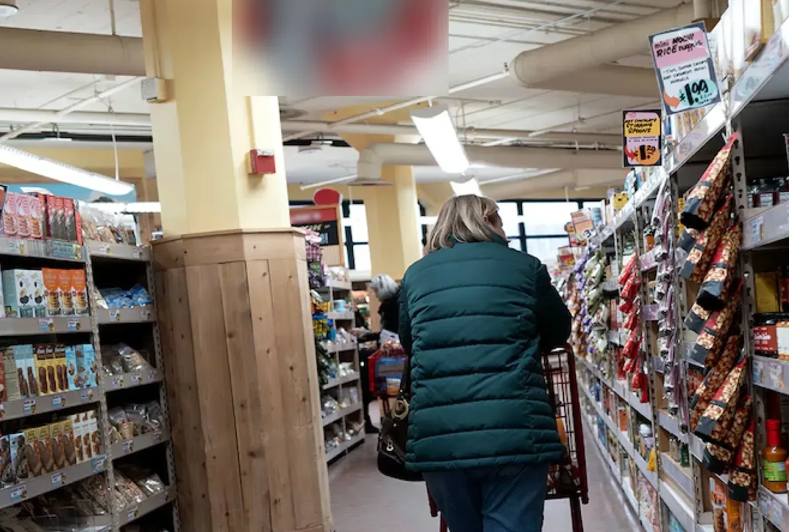 A shopper browsing a grocery aisle