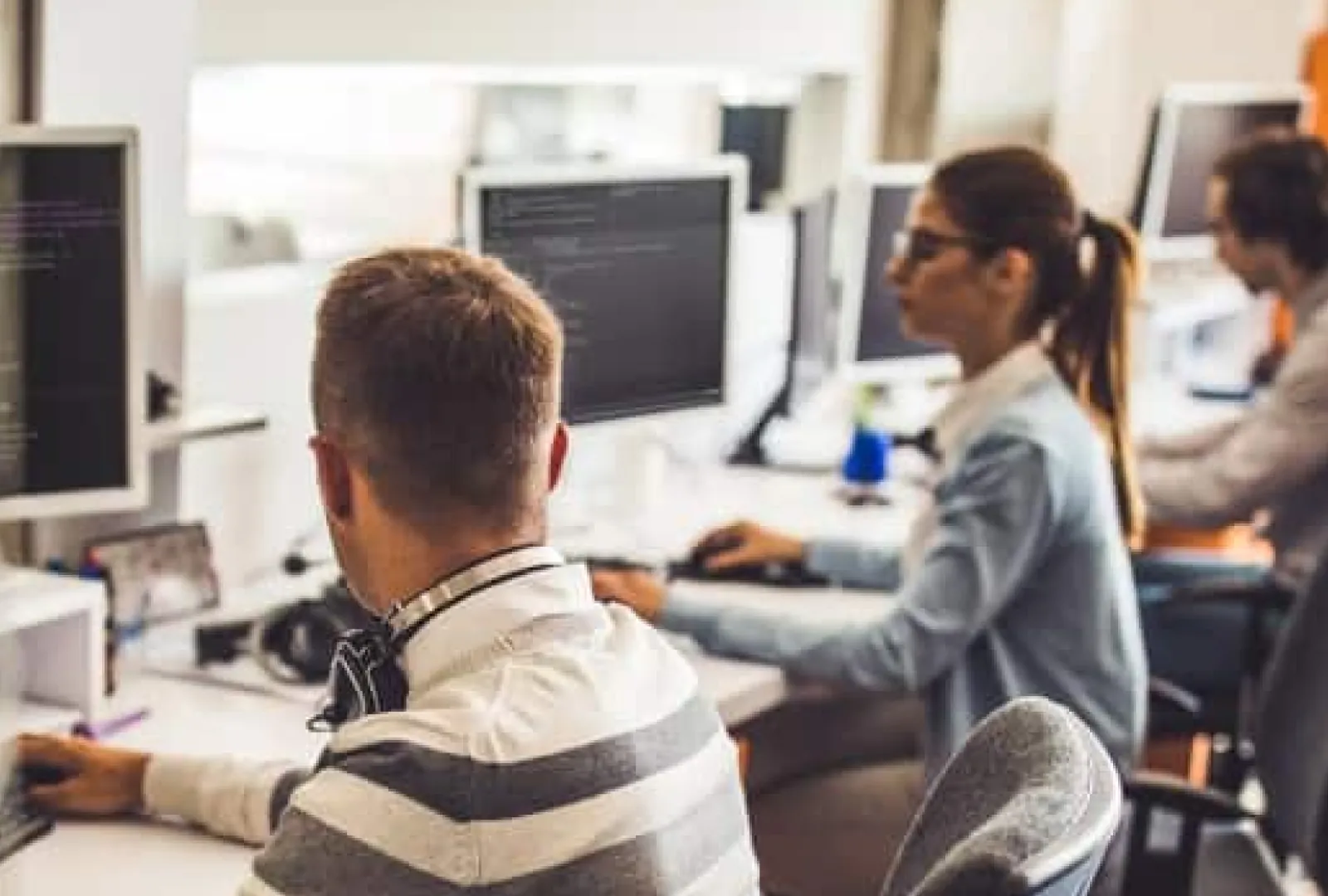 Learners working at computers in a training lab